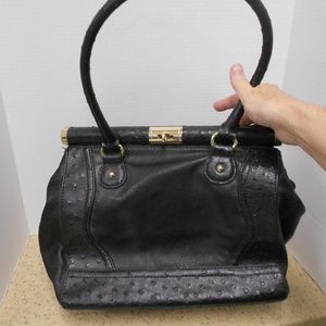 Large, black faux leather bag.